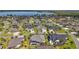 Overview of neighborhood with beautiful homes and manicured lawns, plus a lake view at 4033 Swaying Palm Ct, The Villages, FL 32163