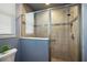 Modern bathroom featuring glass shower with tile surround and mosaic accent at 4033 Swaying Palm Ct, The Villages, FL 32163
