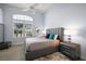 Comfortable bedroom with neutral decor and large window offering natural light at 4033 Swaying Palm Ct, The Villages, FL 32163