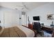 Spacious bedroom featuring a large closet, desk, and a queen-sized bed at 4033 Swaying Palm Ct, The Villages, FL 32163