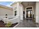 Covered front entry with tiled floor and elegant columns welcomes you to this pristine home at 4033 Swaying Palm Ct, The Villages, FL 32163
