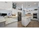 Bright kitchen featuring white cabinetry, granite counters, a kitchen island, and stainless steel appliances at 4033 Swaying Palm Ct, The Villages, FL 32163