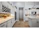 Open kitchen featuring white cabinetry, granite counters, stainless appliances, and modern lighting fixtures at 4033 Swaying Palm Ct, The Villages, FL 32163