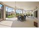 Generous lanai with an outdoor dining area, ceiling fans, and seamless transition to the resort-style pool area at 4033 Swaying Palm Ct, The Villages, FL 32163