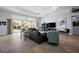 Open living room with access to the pool area, offering bright natural light and stylish furniture at 4033 Swaying Palm Ct, The Villages, FL 32163