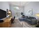 Bright living room featuring high ceilings, modern lighting, desk and comfortable seating at 4033 Swaying Palm Ct, The Villages, FL 32163