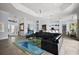 Open-concept living area features tile flooring, tray ceiling, and seamless flow to the kitchen and dining spaces at 4033 Swaying Palm Ct, The Villages, FL 32163