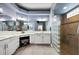 Beautiful main bathroom with dual sinks, granite countertops and a glass block shower at 4033 Swaying Palm Ct, The Villages, FL 32163