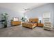 Spacious main bedroom with vaulted ceilings, offering a serene retreat with stylish furnishings at 4033 Swaying Palm Ct, The Villages, FL 32163