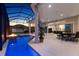 Covered patio featuring a screened-in pool, outdoor dining area, and ceiling fans at 4033 Swaying Palm Ct, The Villages, FL 32163