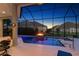 Sparkling screened-in pool with a fire feature and view of adjacent homes at 4033 Swaying Palm Ct, The Villages, FL 32163