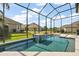 Beautiful screened-in pool with a modern waterfall fire feature offers a private and luxurious outdoor retreat at 4033 Swaying Palm Ct, The Villages, FL 32163