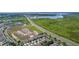Neighborhood aerial view, houses near lake and highway, showcasing community layout at 422 Rock Springs Cir, Groveland, FL 34736