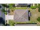 Aerial view of a house showcasing its roof and surrounding landscaped yard at 422 Rock Springs Cir, Groveland, FL 34736