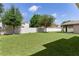 Expansive backyard featuring lush green grass and a well-maintained fence offers privacy and ample space at 422 Rock Springs Cir, Groveland, FL 34736