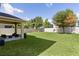 Large, well-manicured backyard with a cozy patio, great for relaxation and gatherings at 422 Rock Springs Cir, Groveland, FL 34736