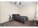 A comfortable bedroom features neutral colored walls, ceiling fan and coordinated bedding, providing a relaxing space at 422 Rock Springs Cir, Groveland, FL 34736