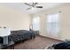 This bedroom features two windows, a ceiling fan, and neutral color walls with coordinated bedding at 422 Rock Springs Cir, Groveland, FL 34736