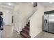 Spacious entryway with tile flooring, leading to a staircase, kitchen, and front door at 422 Rock Springs Cir, Groveland, FL 34736