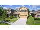 Two-story home with manicured lawn and dark shutters, set in a suburban neighborhood at 422 Rock Springs Cir, Groveland, FL 34736