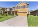 A well-manicured lawn complements the two-story home with an attached garage and simple shrubbery at 422 Rock Springs Cir, Groveland, FL 34736