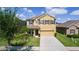 Two-story home with attached garage and simple landscaping providing an attractive curb appeal at 422 Rock Springs Cir, Groveland, FL 34736