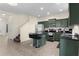 Bright kitchen featuring tile floors, stainless steel appliances, a breakfast bar island with seating, and a view of the entry stairs at 422 Rock Springs Cir, Groveland, FL 34736