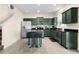 Open kitchen features stainless steel appliances, dark granite counters, tile flooring, and a breakfast bar island with seating at 422 Rock Springs Cir, Groveland, FL 34736