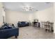 Cozy living room with tile flooring, ceiling fan, comfortable seating, and a decorative rug creating a welcoming atmosphere at 422 Rock Springs Cir, Groveland, FL 34736