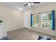 Bright living room features neutral walls, tile flooring, and natural light from large windows at 422 Rock Springs Cir, Groveland, FL 34736