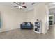Cozy living room area with neutral walls, tile floors, love seat and shelving at 422 Rock Springs Cir, Groveland, FL 34736