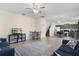 Open-concept floor plan featuring tile flooring, neutral walls, comfortable furniture and seamlessly connects the living area and kitchen at 422 Rock Springs Cir, Groveland, FL 34736