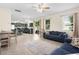 Open living space showcases connection with kitchen with tile flooring, neutral walls, windows, and comfortable furniture at 422 Rock Springs Cir, Groveland, FL 34736