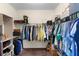 Spacious walk-in closet with double hanging rods and shelving offers ample storage space for clothing and accessories at 422 Rock Springs Cir, Groveland, FL 34736