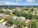Aerial view of a neighborhood with many trees and blue sky at 4314 Arlington Ridge Blvd, Leesburg, FL 34748