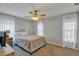 Bedroom with neutral paint, carpet, and white curtains at 4314 Arlington Ridge Blvd, Leesburg, FL 34748