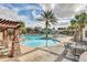 Resort-style pool area with palm trees, cabanas, and comfortable seating for relaxation at 4314 Arlington Ridge Blvd, Leesburg, FL 34748