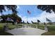 A patriotic tribute featuring American flags, memorial stones, and peaceful seating, set in a beautiful setting at 4314 Arlington Ridge Blvd, Leesburg, FL 34748