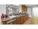 Kitchen bar counter, complete with updated stainless-steel appliances and warm wood cabinetry at 4314 Arlington Ridge Blvd, Leesburg, FL 34748