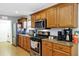 Well-equipped kitchen with stainless steel appliances and warm wood cabinetry at 4314 Arlington Ridge Blvd, Leesburg, FL 34748
