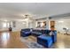 Open-concept living space with tile floors, a large sectional, and views of the kitchen and foyer at 4314 Arlington Ridge Blvd, Leesburg, FL 34748