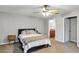 The primary suite features plush carpeting, a ceiling fan, and access to an ensuite bathroom at 4314 Arlington Ridge Blvd, Leesburg, FL 34748