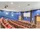 Community theater with tiered seating, projector, and dark blue walls at 4314 Arlington Ridge Blvd, Leesburg, FL 34748