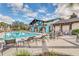 Inviting pool area with ample seating, palm trees, and a clubhouse in the background at 4314 Arlington Ridge Blvd, Leesburg, FL 34748