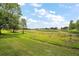 Large backyard with mature trees and expansive green space at 5300 Tigers Tail, Leesburg, FL 34748