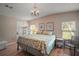 Bright bedroom with hardwood floors and large windows offers ample natural light at 5300 Tigers Tail, Leesburg, FL 34748