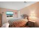 Cozy bedroom with ample natural light and laminate wood flooring at 5300 Tigers Tail, Leesburg, FL 34748