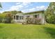 Well-maintained home with lush landscaping and a green lawn at 5300 Tigers Tail, Leesburg, FL 34748