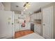 Efficient kitchen with white cabinets, appliances, and bright, overhead lighting at 5300 Tigers Tail, Leesburg, FL 34748