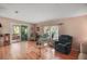 Inviting living room with hardwood floors and sliding door access to the sunroom at 5300 Tigers Tail, Leesburg, FL 34748